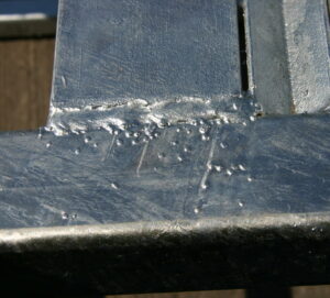 Area of weld spatter not removed prior to galvanizing